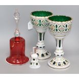 A pair of Bohemian green glass and white overlay 'chalices' with floral decoration, a similar bell