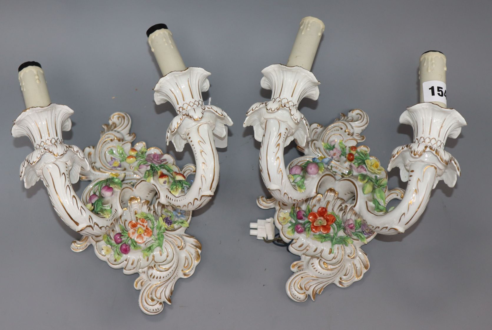 A pair of Dresden two branch wall sconces