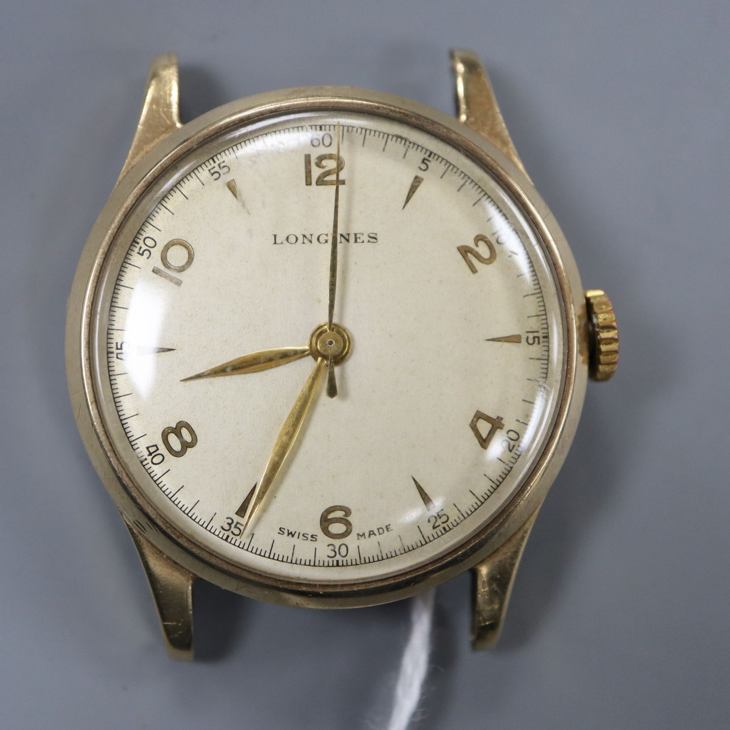 A gentleman's 9ct. gold Longines manual wind wrist watch, with baton & Arabic numerals (strapless).