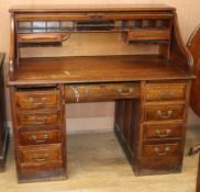 A 1920's oak roll top desk with 'S' shape tambour W.126cm