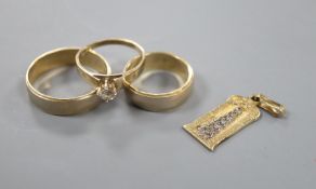 Two 14ct two-colour gold wedding bands, a yellow and white metal pendant (tests as 14ct) and a