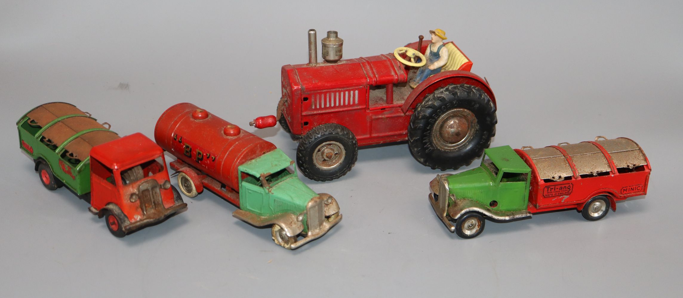 Three Minic trucks and a German tractor