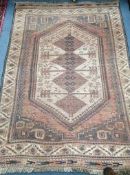 A Turkish red ground rug 120 x 170cm