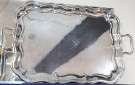 A George V silver shaped rectangular two handled tea tray, marks rubbed, Birmingham, 1930?, 66.4cm