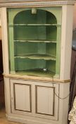 A Georgian style cream, gilt and green painted standing corner cupboard W.116cm