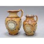 Two Doulton Lambeth motto jugs, c.1890, both with mask and portrait medallions, the largest with