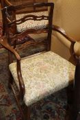 A George III mahogany ladderback elbow chair