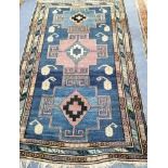 A blue ground rug 120 x 185cm