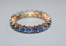 A 375 yellow metal and sapphire set full eternity ring, size O.