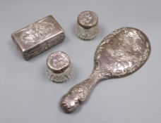An Edwardian repousse silver 'Reynold's Angels' soap box by William Comyns, a silver hand mirror and