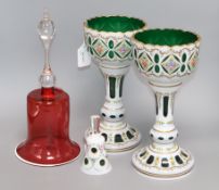 A pair of Bohemian green glass and white overlay 'chalices' with floral decoration, a similar bell