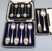 Three assorted cased sets of silver flatware including a christening pair and coffee spoons.