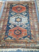 A blue and red ground rug 125 x 175cm