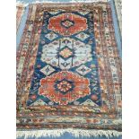 A blue and red ground rug 125 x 175cm