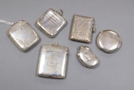 Six assorted early 20th century silver vesta cases including moon shape and kidney shape with bust