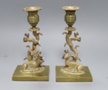 A pair of polished bronze stag candlesticks H.19cm