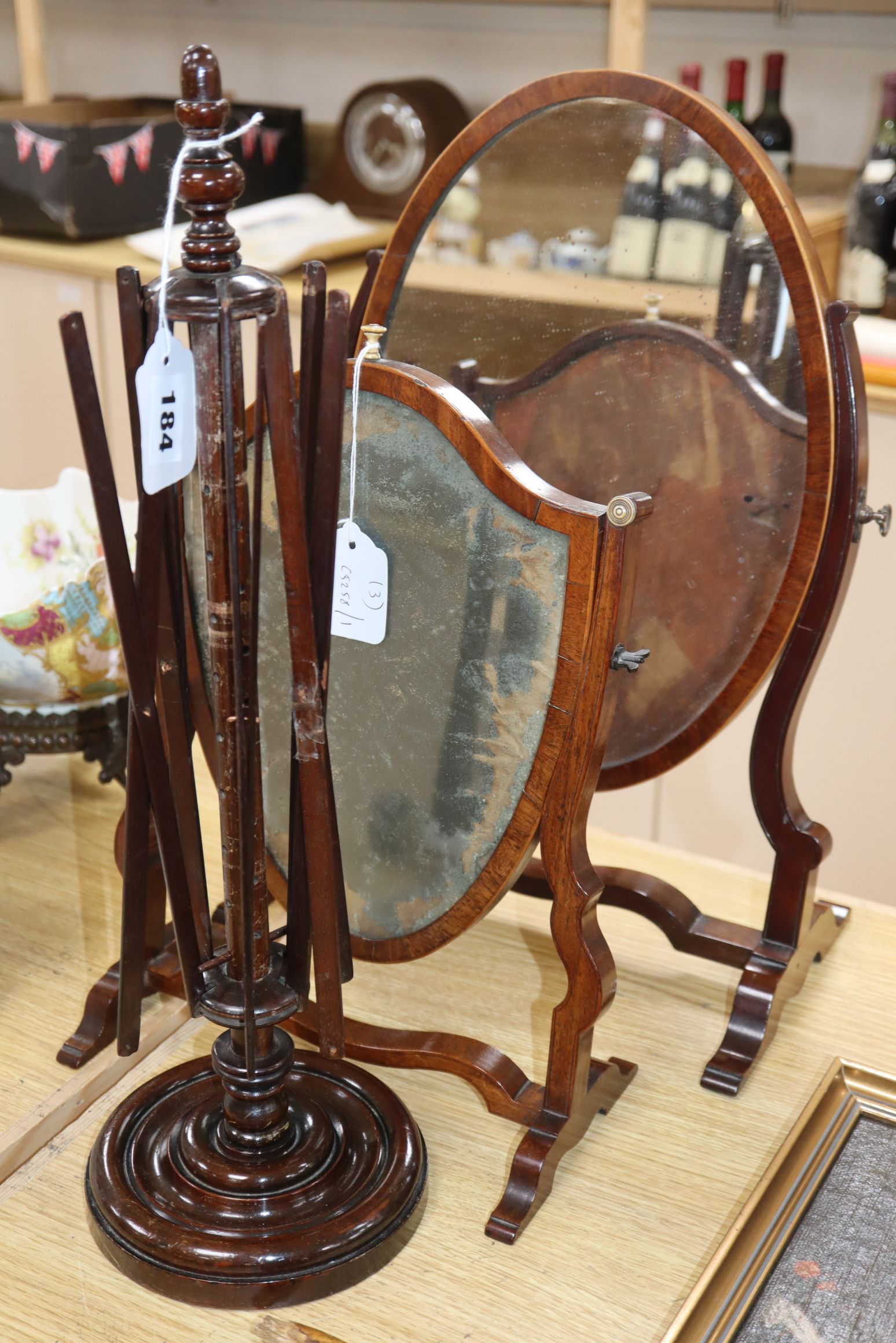 Two 19th century skeleton frame toilet mirrors and a wool winder Largest mirror H.48cm