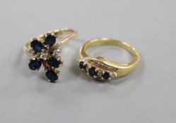 An 18ct gold, sapphire and diamond crossover ring and a 585 yellow metal and sapphire ring.