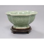 A Chinese celadon dish on stand