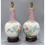 A pair of Chinese bottle-shaped vase table lamps, decorated with flowers in polychrome enamels
