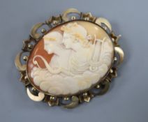 A early 20th century yellow metal mounted oval cameo brooch, carved with two muses, 7cm.