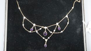 A 375 yellow metal, cabochon amethyst and seed pearl set drop necklace, 62cm.