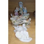 A pair of Continental porcelain horse and cart figures five eight others