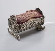 A late Victorian novelty repousse silver mounted cradle pin cushion, Saunders & Shepherd,