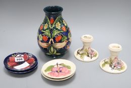 A Moorcroft vase, a pair of dwarf candlesticks and four pin dishes