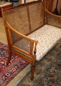 A painted caned settee W.115cm