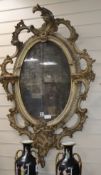 A Victorian gilt gesso and carved wood wall mirror, with an oval plate W.80cm