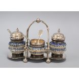 A Doulton Lambeth three piece cruet set, with plated mounts and frame, dated 1880, total width 19.