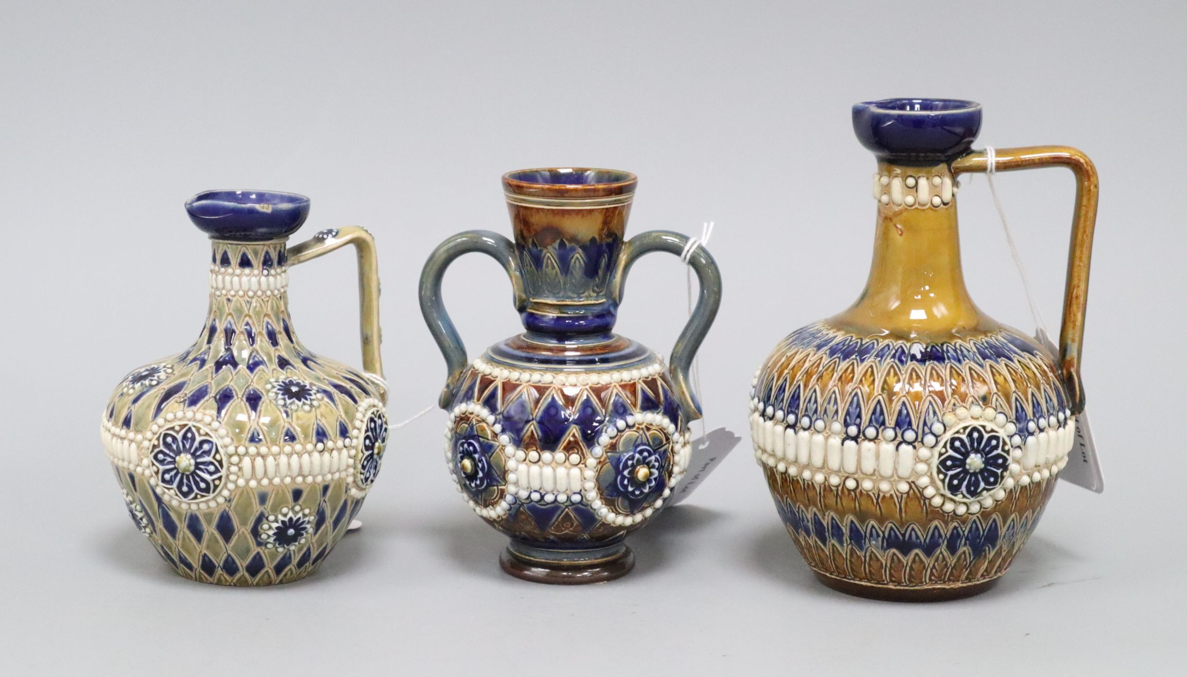 Two Doulton Lambeth incised and 'jewelled' jugs and a similar 2-handled vase, c.1885-1910, 12cm -