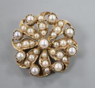 A yellow metal and split pearl cluster set flower head brooch, 24mm.