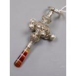 A late Victorian repousse silver child's rattle, with banded agate handle, six bells and a