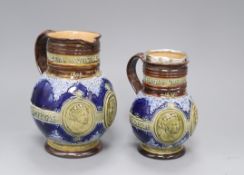 Two Doulton Lambeth graduated Queen Victoria Diamond Jubilee commemorative jugs, c.1896/7, with