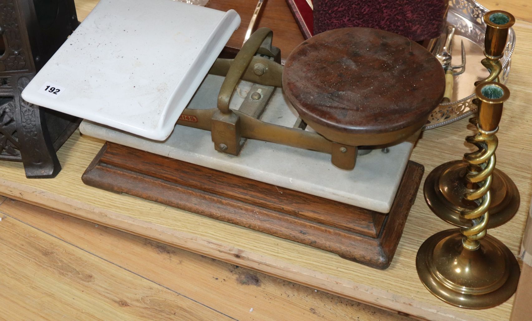 A cast iron conservatory heater, scales and brass candlesticks