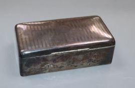 A George V silver cigarette box, 17.2cm.