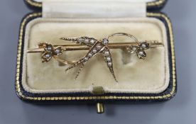 A Victorian style 9ct gold, diamond and seed pearl set 'swallow' bar brooch, 46mm.