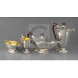 A George VI Art Deco silver four piece pedestal tea set by Adie Brothers, of shaped rounded