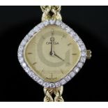 A lady's modern 14ct gold and diamond set Omega quartz dress wrist watch, the shaped dial with baton