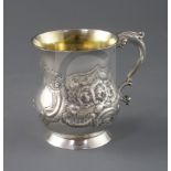 A George III Irish silver mug by Matthew West, of baluster form, with later? embossed foliate and