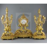 A 19th century French ormolu clock garniture, modelled with putti supporting urns, floral swags