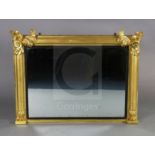 A William IV giltwood overmantel mirror, with foliate scroll capped pilasters, reeded ebonised