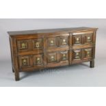 A 17th century style oak dresser base, fitted six geometric moulded drawers with drop handles, on