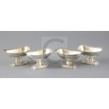 A set of four George III Irish silver pedestal salts by James Scott, of rounded rectangular form,