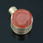 A small 19th century engraved gold and carnelian set moon shaped scent flask, one carnelian carved