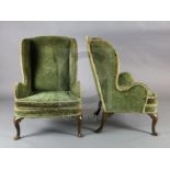A pair of 19th century George I style mahogany wing armchairs, with scroll carved cabriole legs on