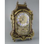 A 19th century French ormolu mounted red tortoiseshell mantel clock, with enamelled tablet