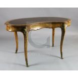 A Victorian crossbanded walnut kidney shaped writing table, the frieze drawer bearing Gillow & Co